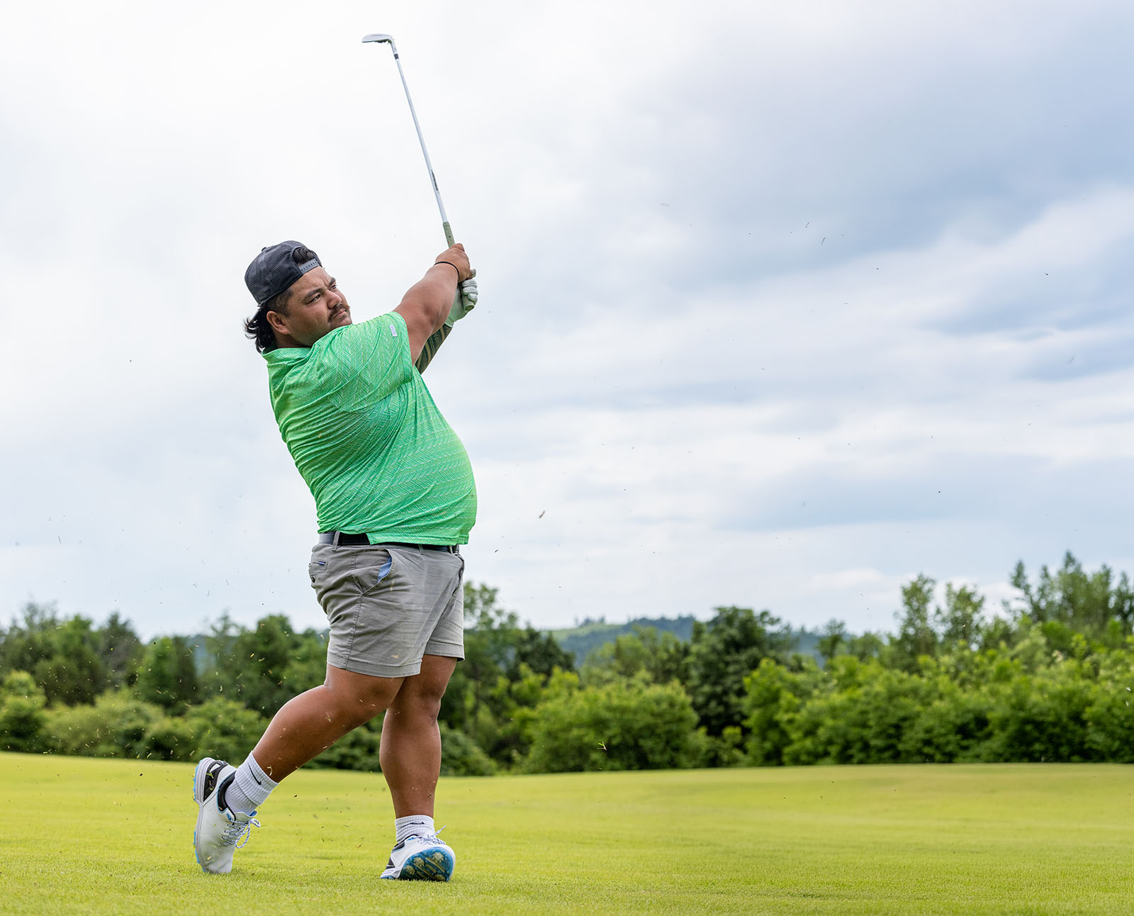 An image of a golf pro swinging on the course.