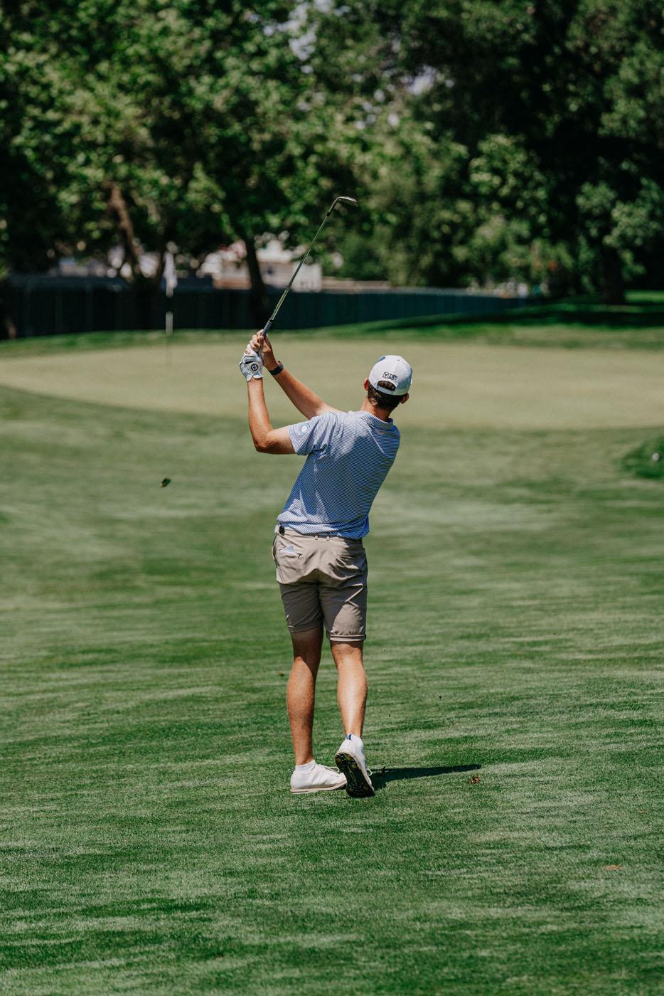An image of a golfer on an outdoor course - contact Tee Box for a golf swing coach.
