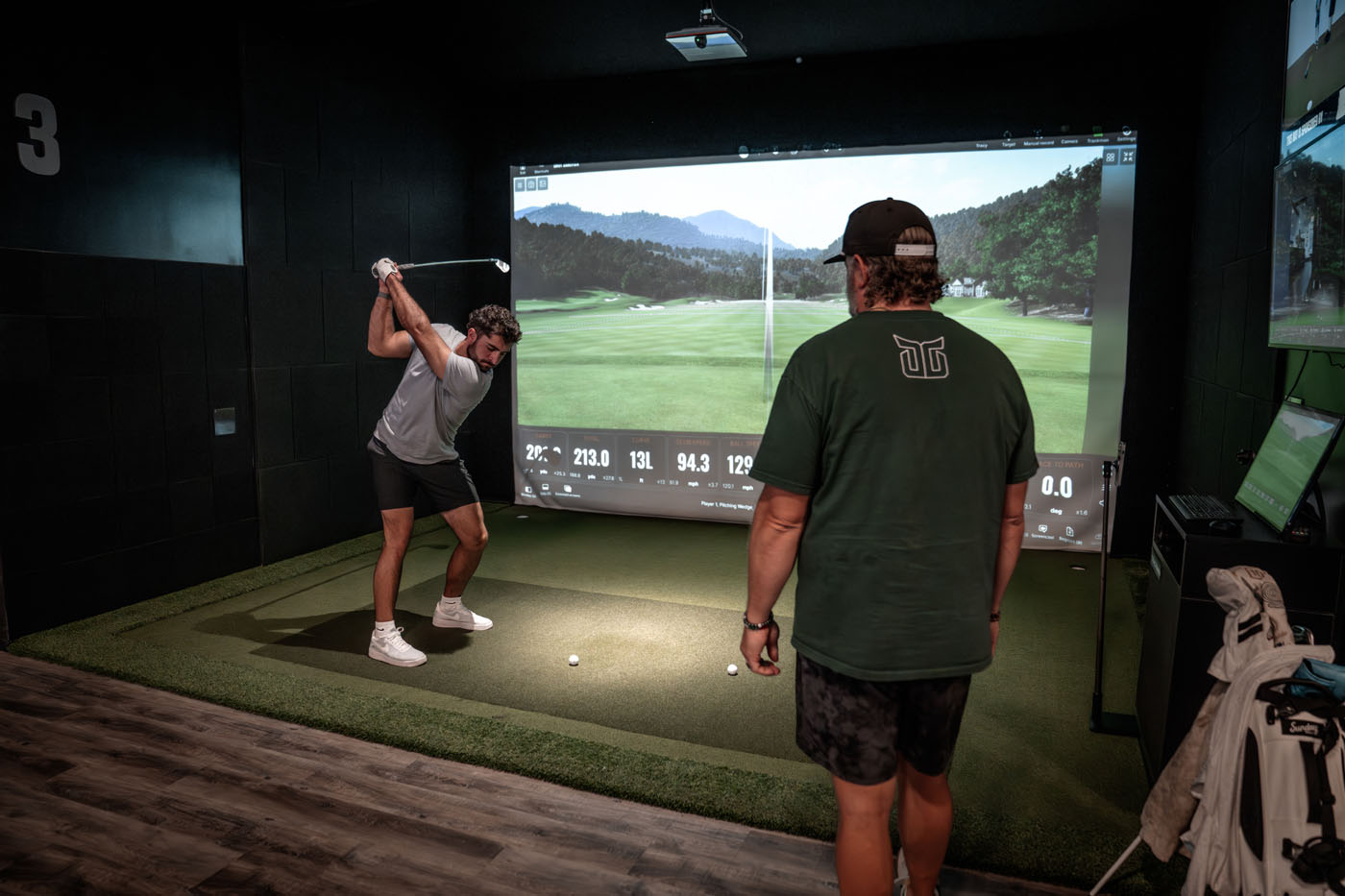 A man using TrackMan Technology at a Tee Box location during golf lessons for adults.