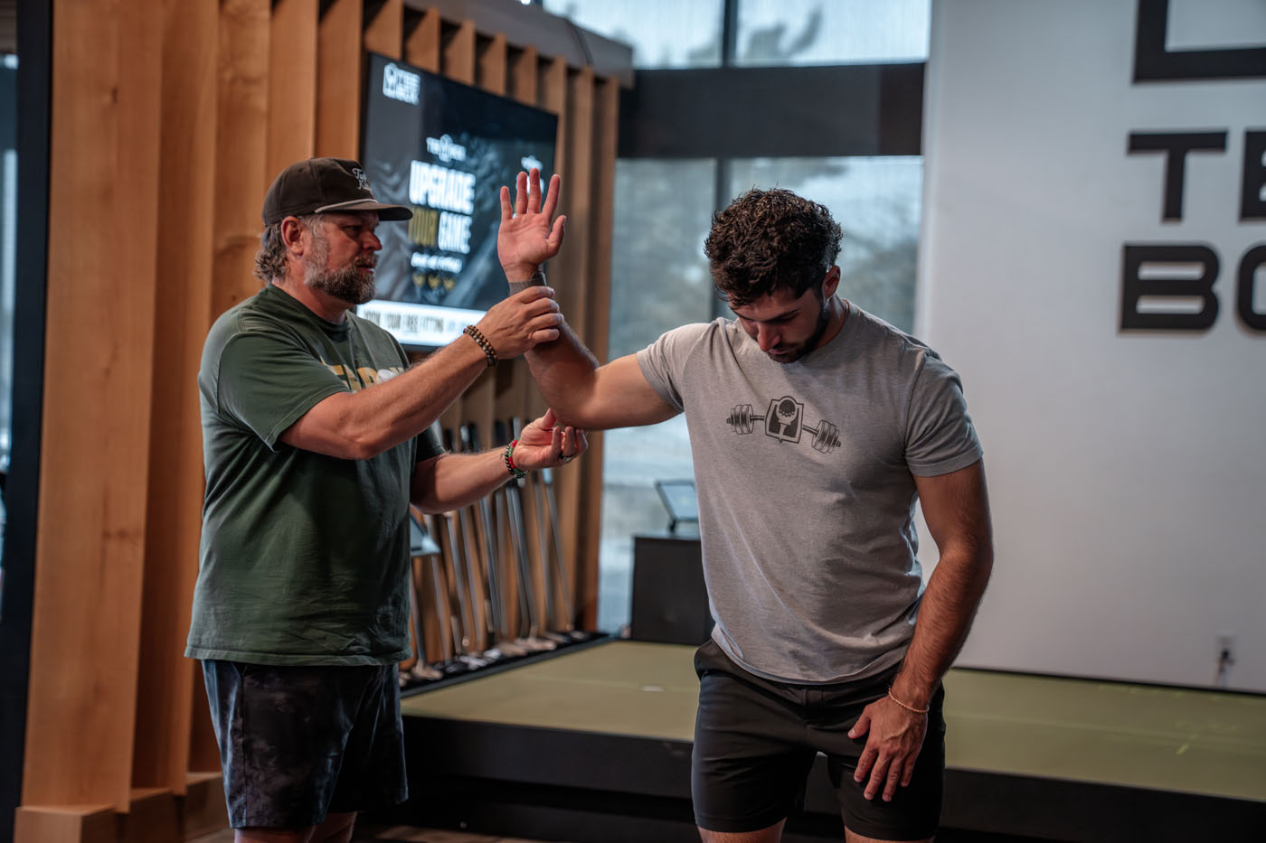 A Tee Box Pro assessing a golfer's mobility in our golf gym.