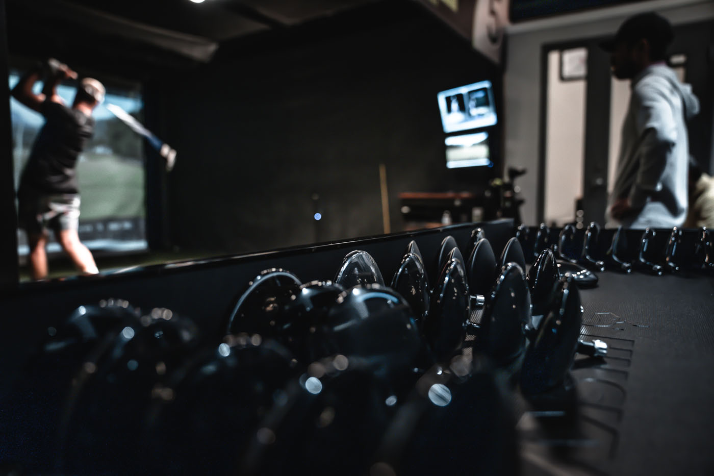 An image of Tee Box equipment and a golfer using our sim bay.
