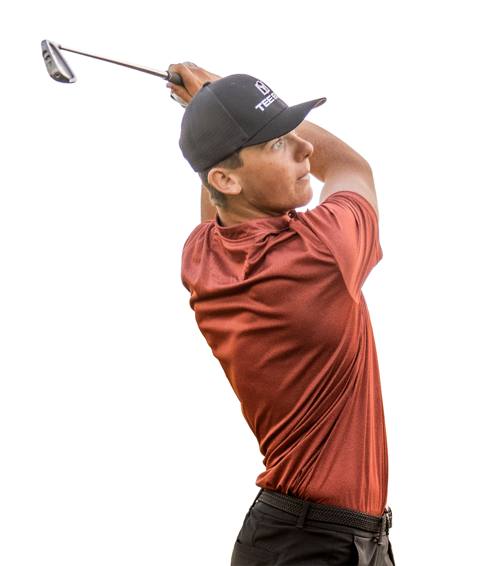 A man swinging his club while using a Tee Box indoor golf course.