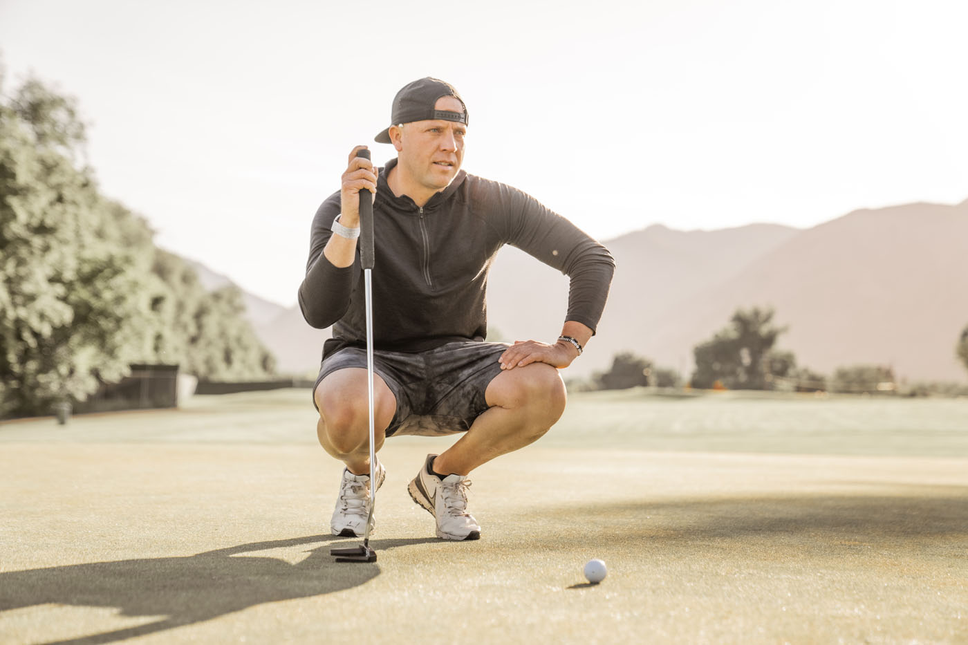 A golfer on a Tee Box outdoor golf course - find support and training you need to become an athlete at our Gilbert adult golf lessons.