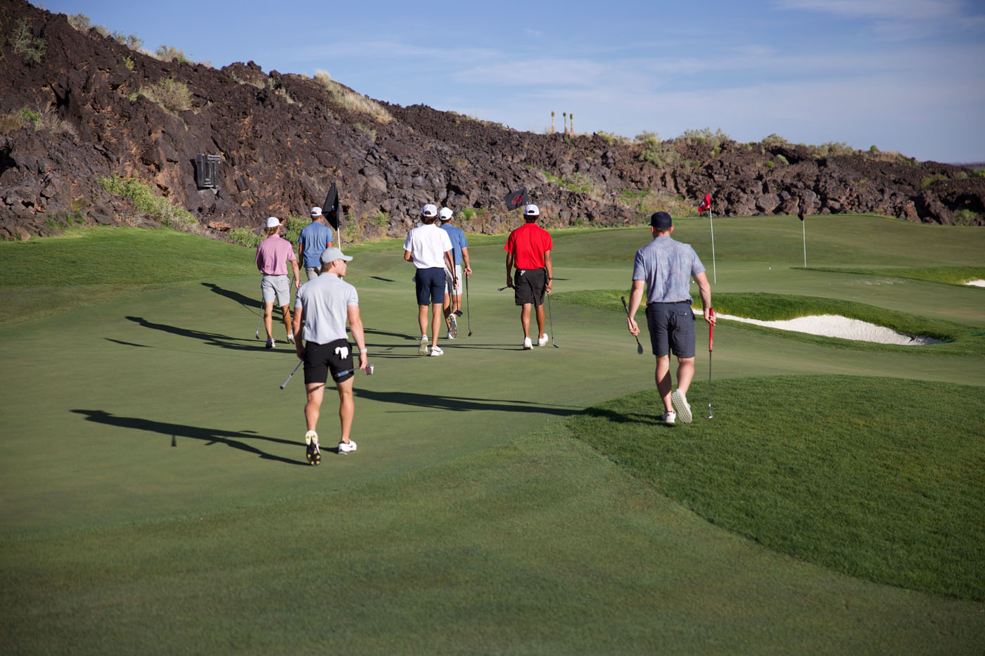 Tee Box golfers on an outdoor course.