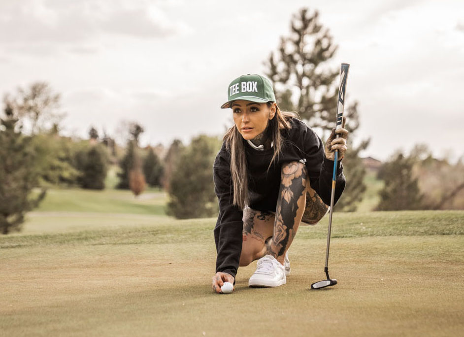 An image of golfer Taylor Nicole lining up a shot on a green.