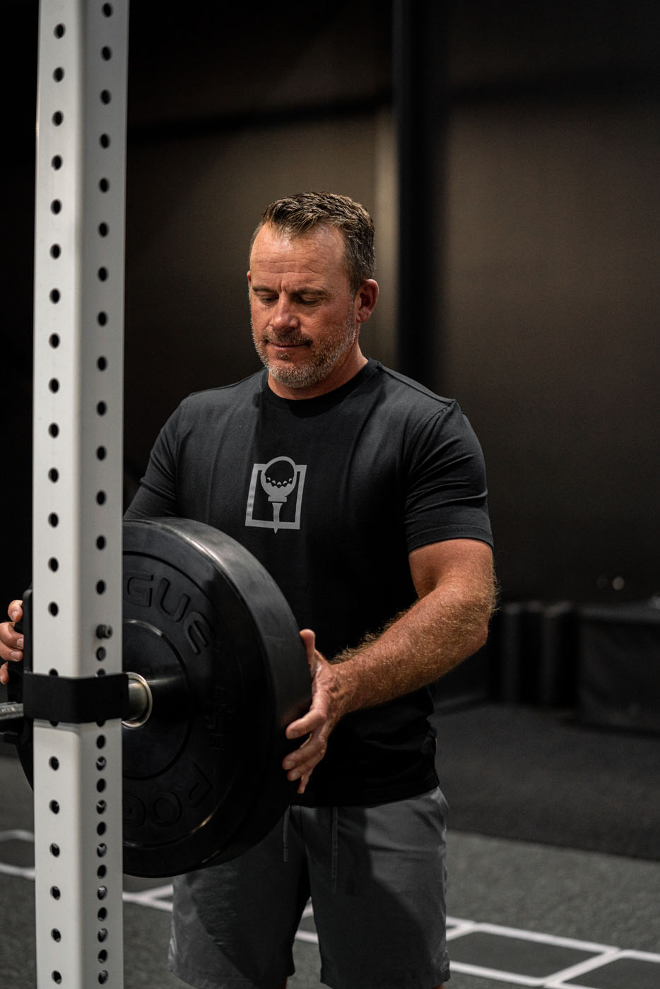 A golfer working on strength training in a Tee Box facility.