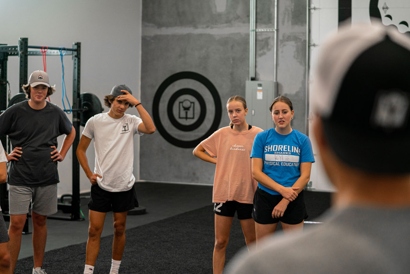 A group of teenagers participating in youth golf lessons with Tee Box